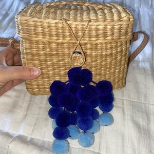 Nannacay straw bag with blue pom poms